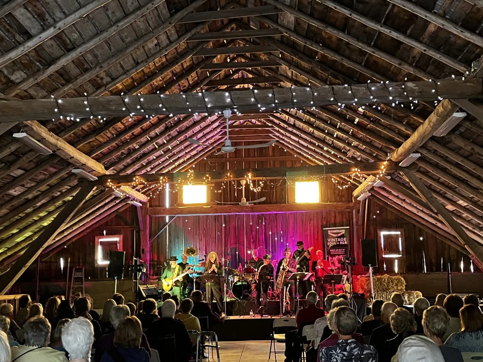 A live concert beneath the barn’s exposed timber beams and string lights